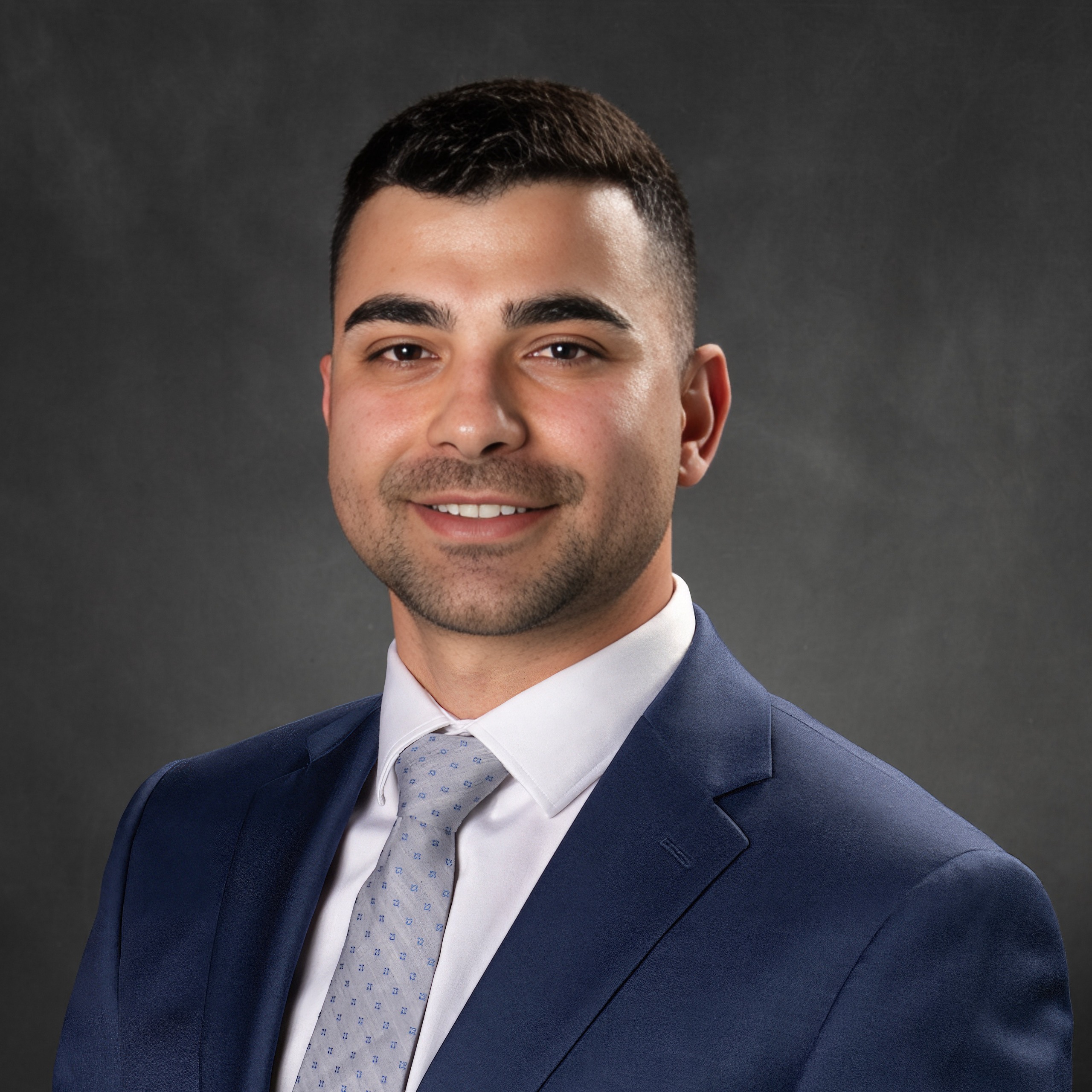 Portrait photo of smiling manager wearing a suit