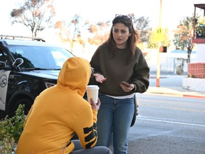 Homeless Services staff surveying a homeless individual on the sidewalk during the 2026 Homeless Count in Glendale.