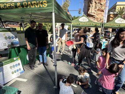 Families engage with City staff and poster boards about the OSCR Elements update during the 2025 GPD Open House.