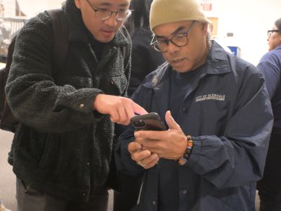 Glendale IT staff and Homeless Services staff review the app used to survey homeless individuals during the 2026 Glendale Homeless Count.