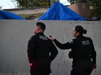Two Glendale Police Officers assess a potential homeless encampment adjacent to SR-134 during the 2026 Glendale Homeless Count.