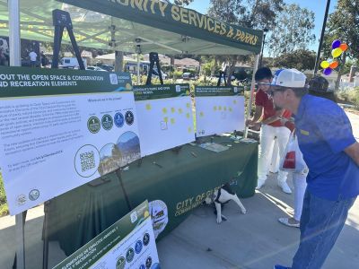 Community member reading poster boards about the OSCR Elements update at the Fremont Park Reopening Event in later 2025.