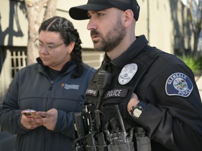A Glendale Memorial Hospital team member and a Glendale Police Officer connect with a homeless individual during the 2026 Glendale Homeless Count.