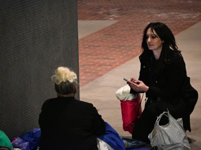 Homeless Services staff share a care bag with an unsheltered homeless individual during the 2026 Homeless Count.